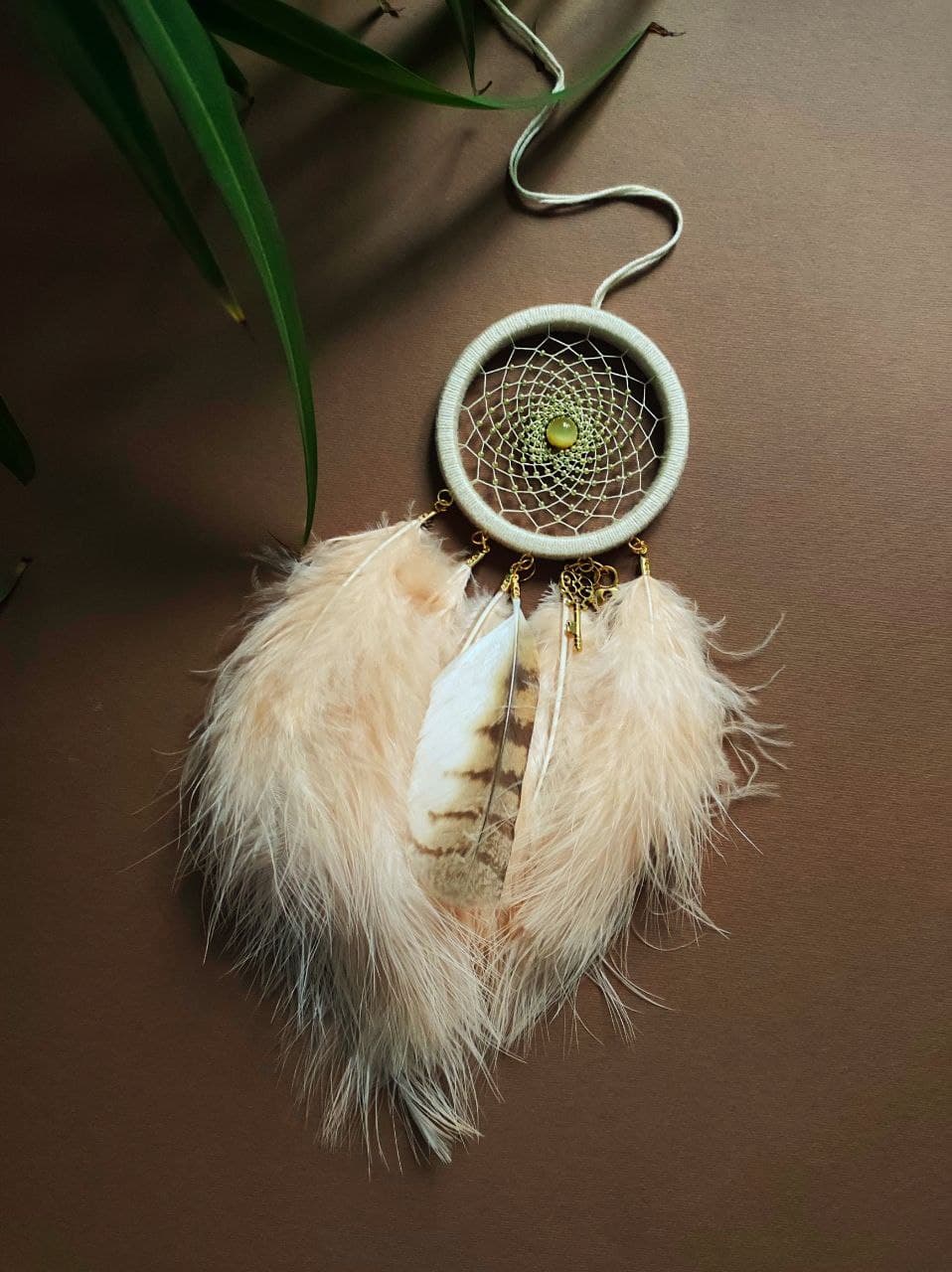 small beige dreamcatcher with natural owl feather