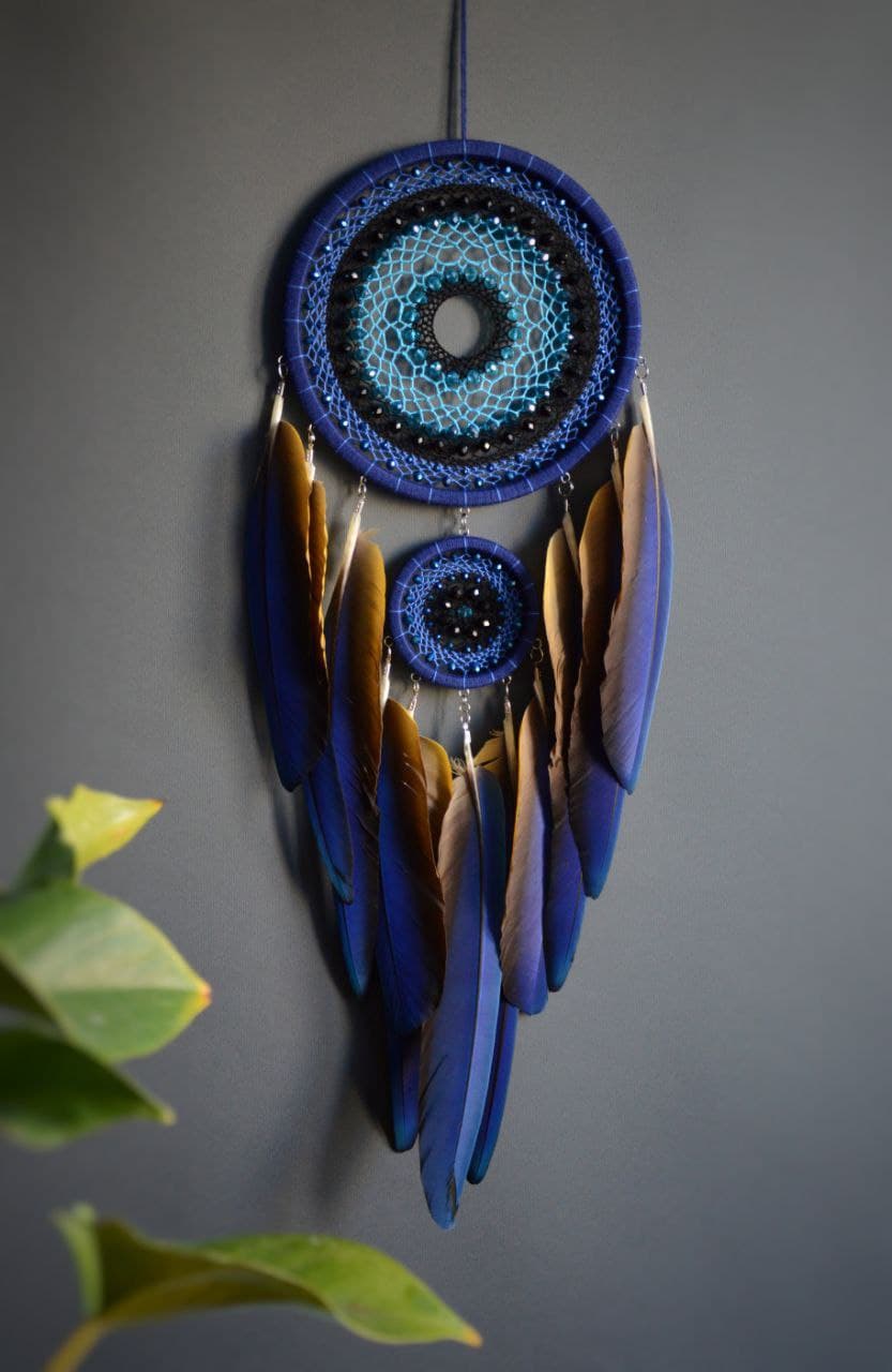 Large blue dream catcher with blue-yellow macaw feathers