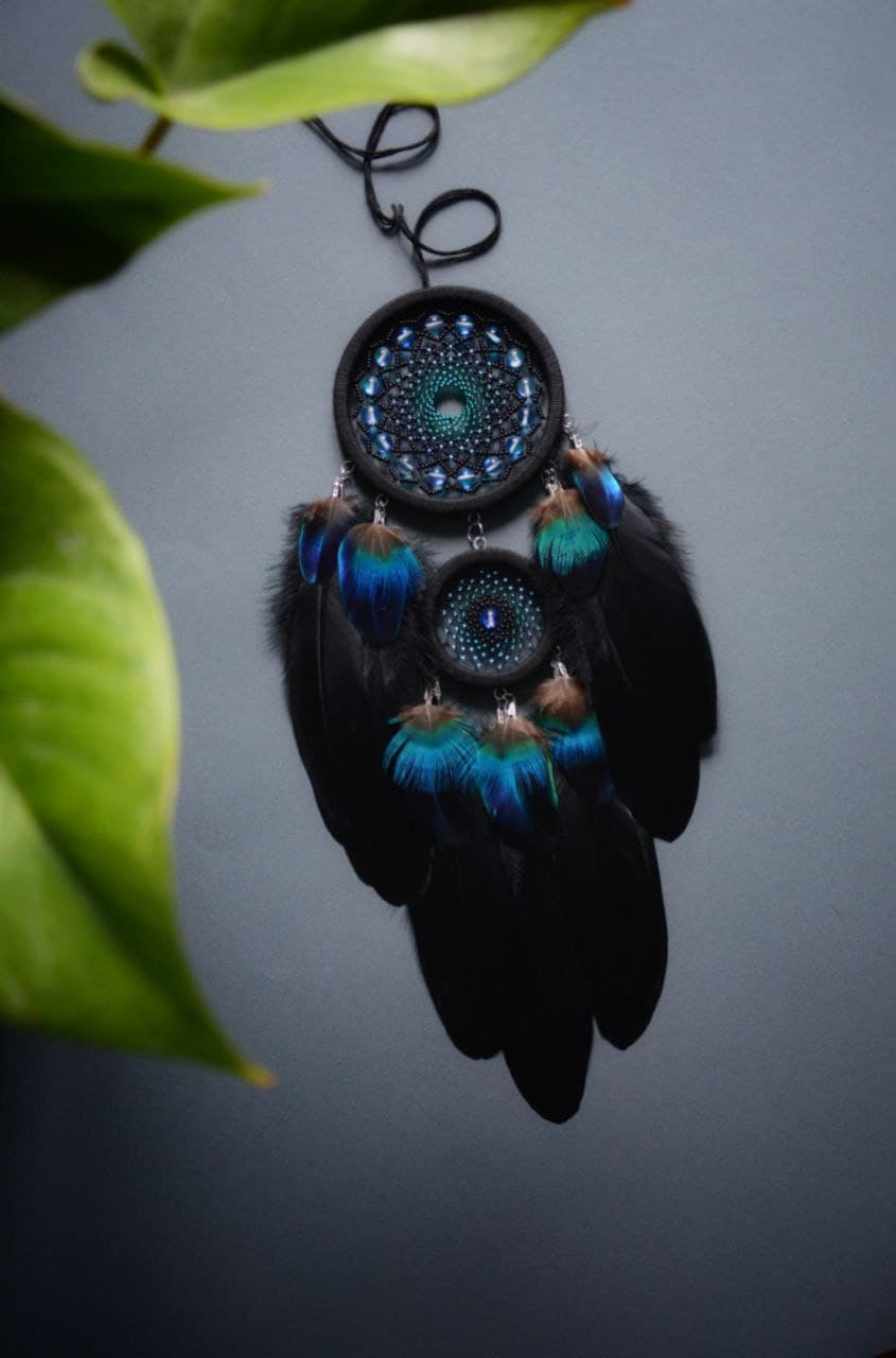Black dream catcher with peacock feathers