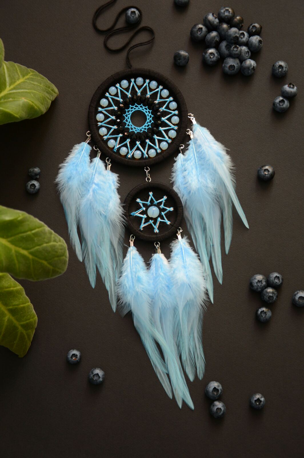 Small black dreamcatcher with blue feathers